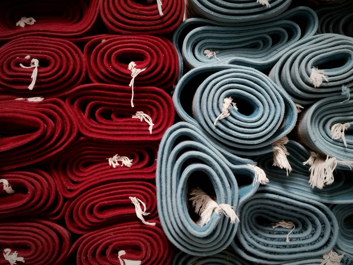 Side-by-side comparison of what is nylon carpet made of versus polyester under microscope